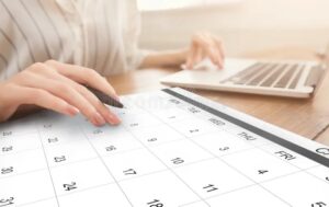 business-scheduling-unrecognizable-woman-working-laptop-checking-calendar-workplace-taking-notes-to-planner-managing-200313800 copy